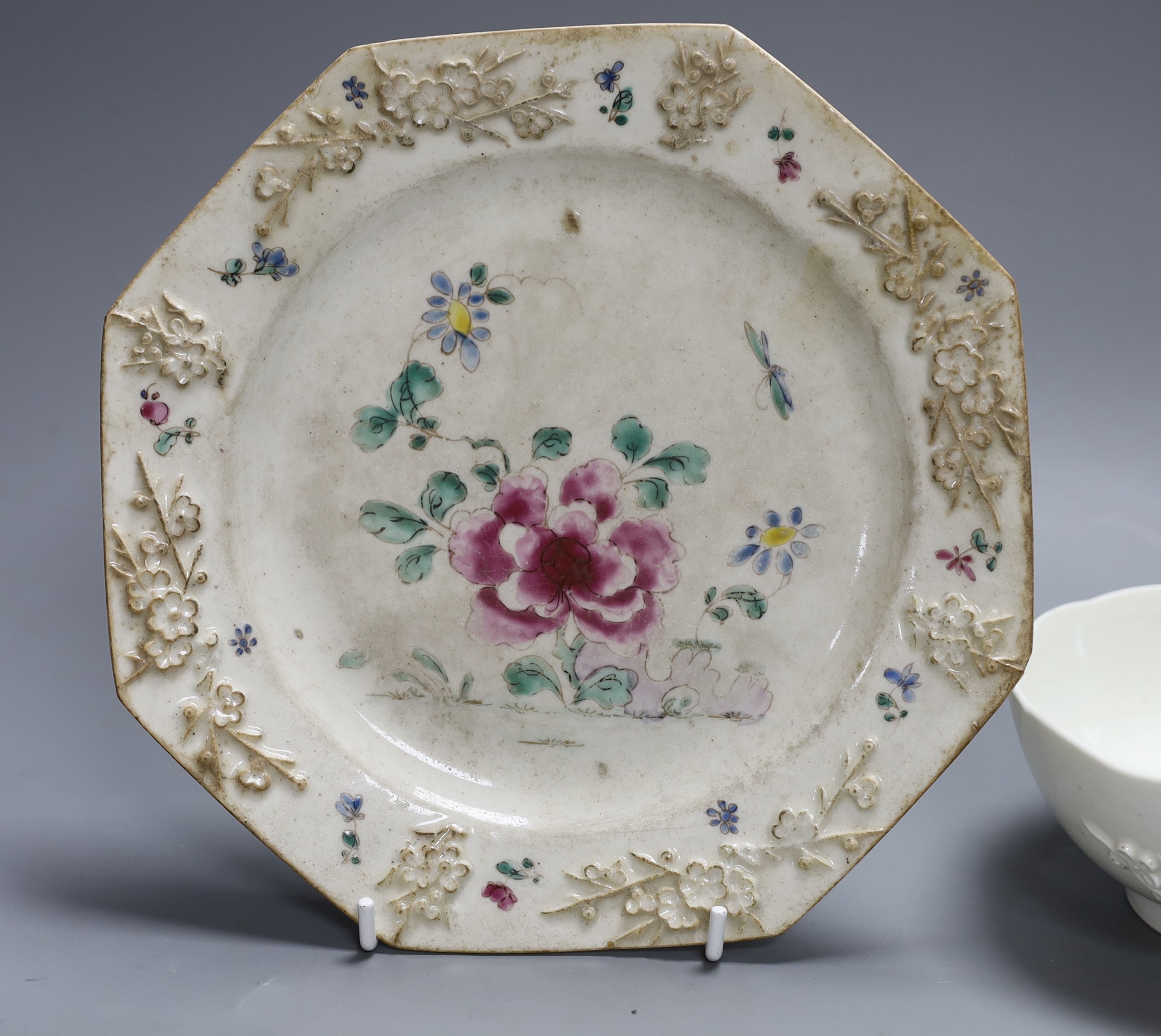 An 18th century Bow white glazed ‘prunus’ bowl, and a Bow octagonal plate, with floral design, 21cm diameter
